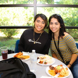 Two students enjoying a meal.