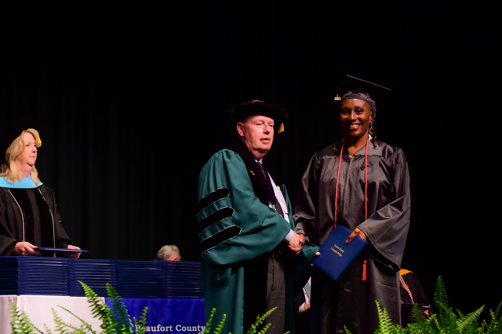 two people shaking hands at graduation