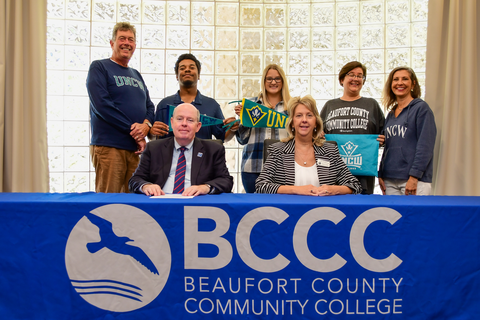 BCCC logo, people holding UNC W things